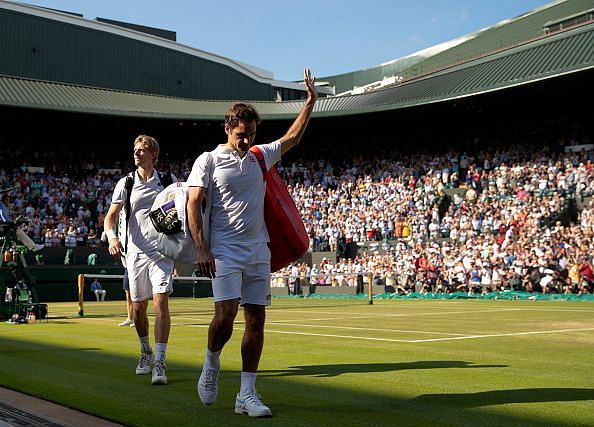 Roger Federer trudges disappointingly off the court following a fifth set defeat to Kevin Anderson