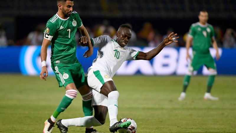 Senegal&#039;s Sadio Mane tussles with Algeria&#039;s Riyad Mahrez during their group C clash