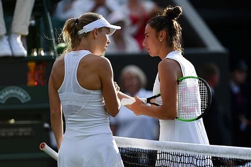 Caroline Wozniacki shakes hands with Sara Sorribes Tormo after she retired from play on Day One at the Championships Wimbledon