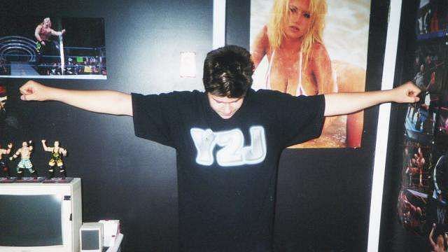 A young Owens posing in his Y2J shirt, years before the two would work together in WWE.