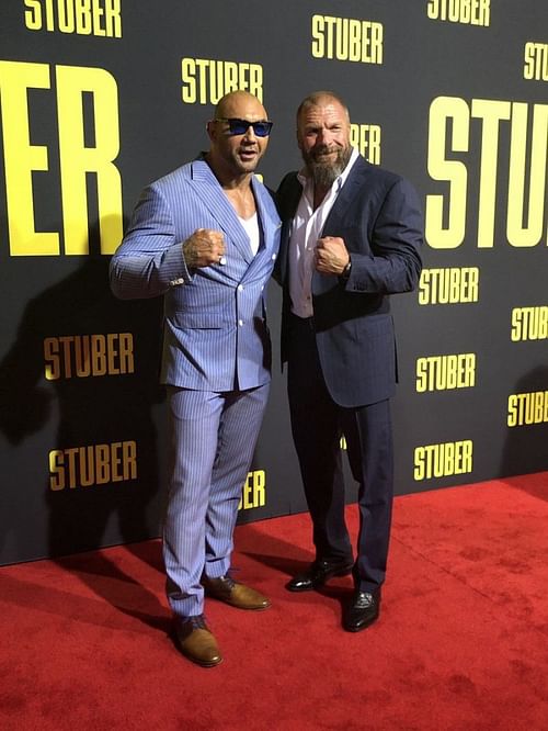 Triple H and Batista are all smiles as they pose together on the red carpet for the debut of Batista's new film: 
