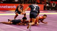 C. Arun grabbing raider Rishank Devadiga's ankle