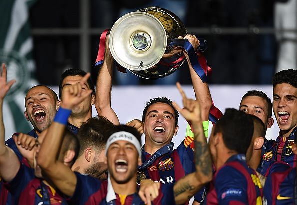 Xavi raises one of many trophies with the Blaugrana.