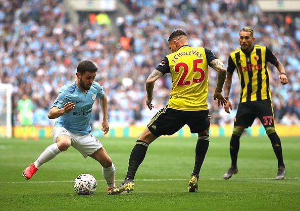 Manchester City&#039;s Silva dribbling to get pass Watford players