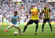 Manchester City's Silva dribbling to get pass Watford players