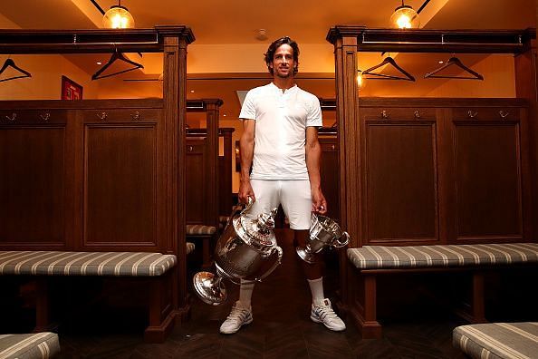 37-year-old wildcard Feliciano Lopez poses with his trophy haul: 2nd Queen&#039;s singles title and first doubles title won with Andy Murray