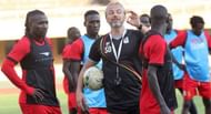 Uganda's gaffer, Sebastien Desabre (c), takes his charges through a training session