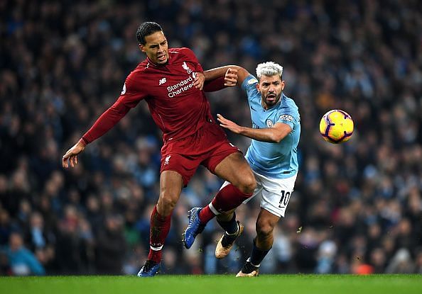 Sergio Aguero (right) and Virjil Van Dijk tussle for the ball.