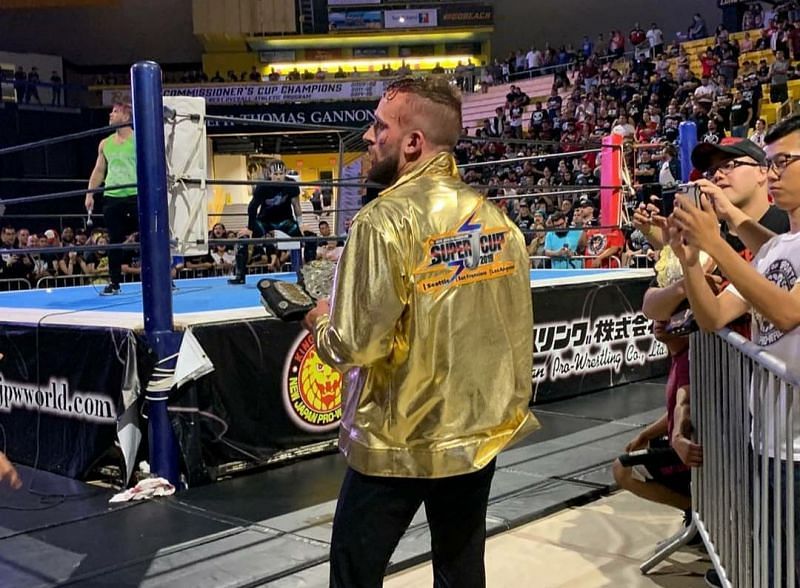 El Phantasmo wearing the Super J-Cup jacket and with the IWGP Jr. Heavyweight Championship