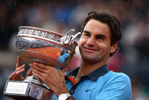 Federer hoists aloft his 15th Grand Slam title and first at the French Open in 2009