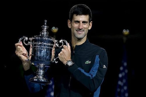 Novak Djokovic poses with his third title at the 2018 US Open