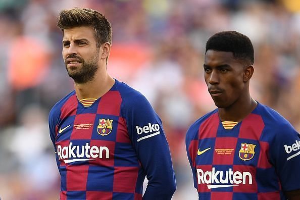 Youngster Junior Firpo stands alongside Gerard Pique.