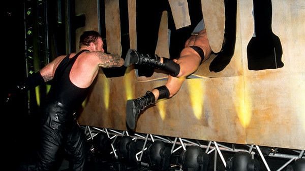 Undertaker sends Brock Lesnar through the stage props at Unforgiven 2002.