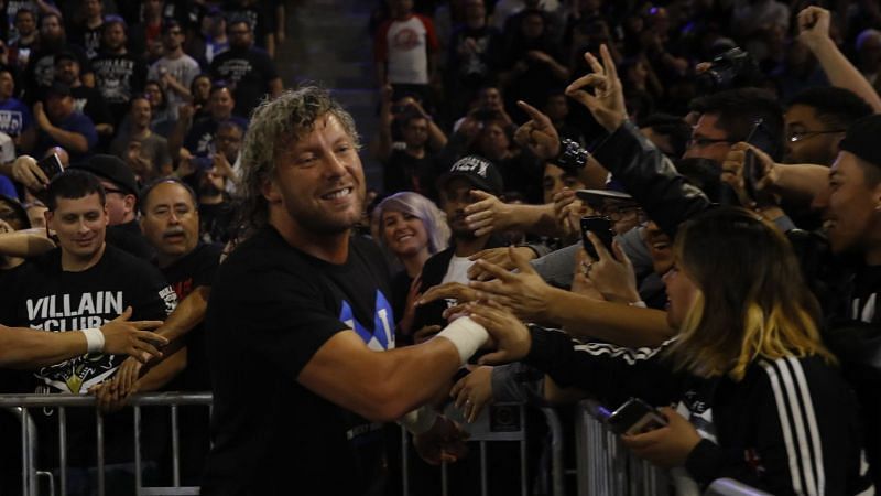 Kenny Omega glad-hands with members of the audience