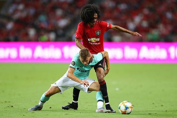 Tahith Chong tussling for the ball against Inter Milan in pre-season