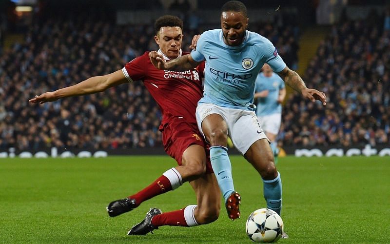 Trent Alexander-Arnold trying to make a successful tackle on Raheem Sterling
