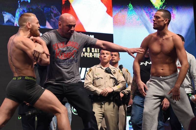 Nate Diaz and Conor McGregor facing off at their weigh-ins