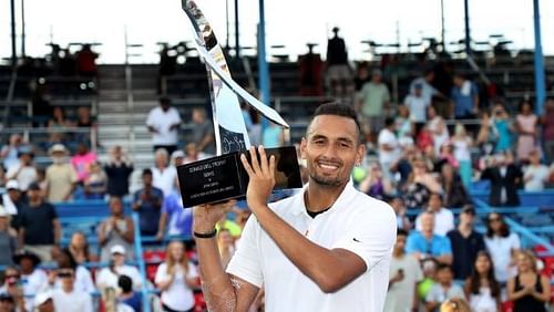 Nick Kyrgios poses with the 2019 ATP 500 Citi Open trophy