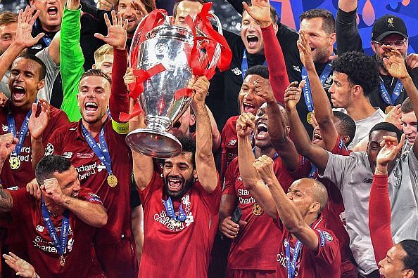 Salah celebrates with the Champions League trophy.