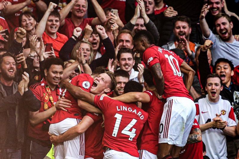 McTominay and the other teammates celebrate with the young James