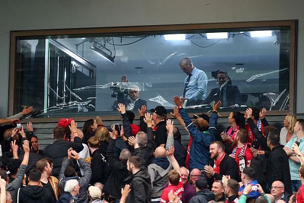 Jose Mourinho waves to fans from the studio.