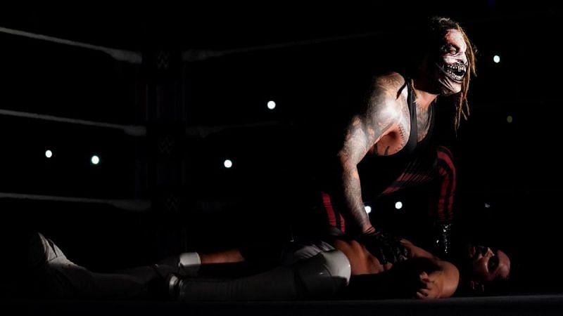 The Fiend placing his hand over Finn Balor