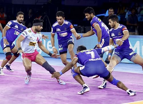 Haryana Steelers players tackle a raider