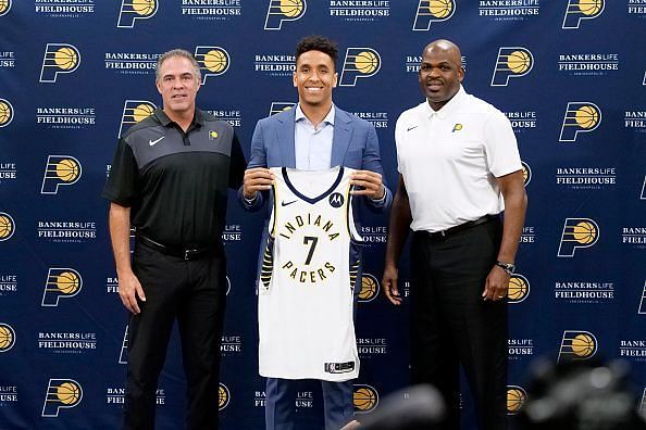 Kevin Pritchard (left) and Nate McMillan (right) with Malcolm Brogdon (center)