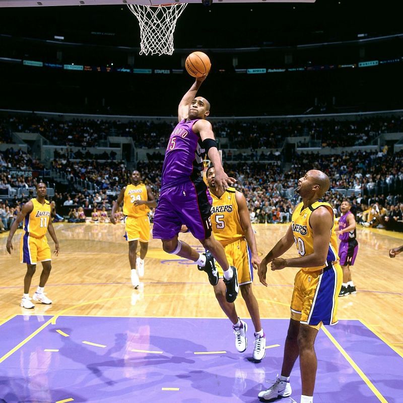 Vince Carter soaring high for a dunk in his Puma sneakers