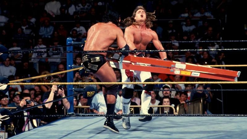 Razor Ramon and HBK punish each other with a steel ladder.