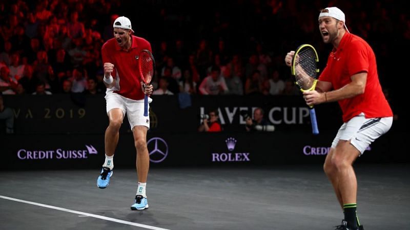 John Isner(left) and Jack Sock exult after their win over Federer and Tsitsipas
