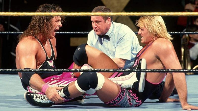 Bret Hart struggles to reverse a figure four leg lock applied by brother Owen at Wrestlemania X.