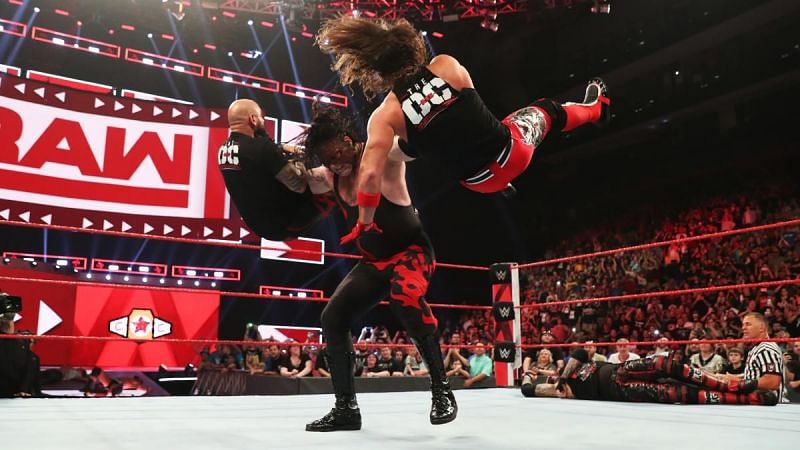 Kane with a double chokeslam on Karl Anderson and AJ Styles.
