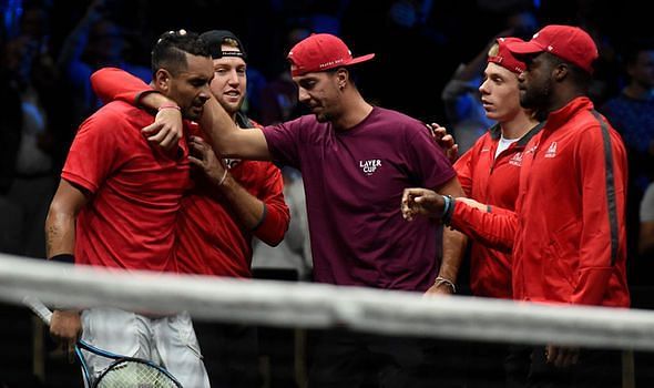 Kyrgios is consoled by teammates after a close defeat to Federer