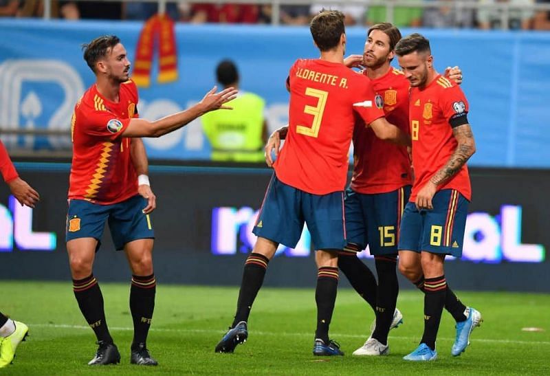 Spain players celebrate with captain Ramos after opening the scoring on the half-hour mark from the spot