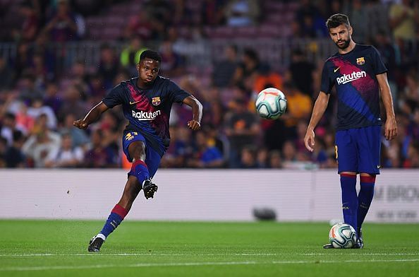 FC Barcelona&#039;s Ansu Fati (L) and Gerard Pique (R)