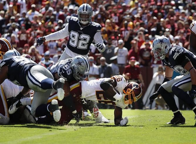 The Latest: Peterson tops Brown with 107th career rushing TD