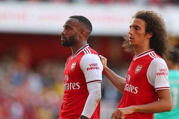 Lacazette and Guendouzi with a muted celebration after the former halved the deficit before half-time