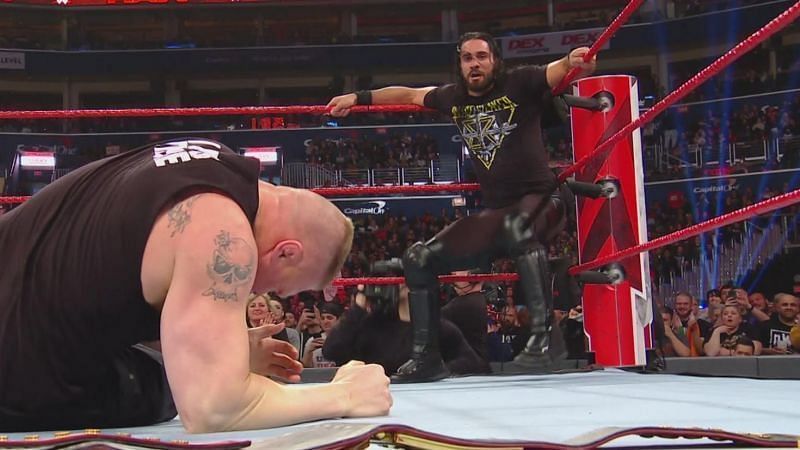 Seth Rollins prepares to hit Brock Lesnar with the Curb Stomp