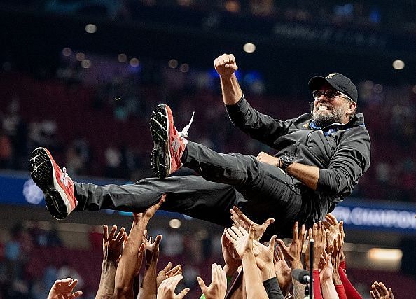 Klopp is held aloft by the Liverpool contingent after the Champions League triumph