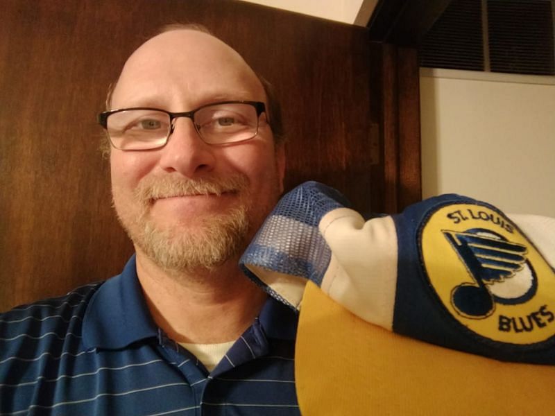 Erik Stone holding a St. Louis Blues hat after the team won their first Stanley Cup on June 12, 2019.