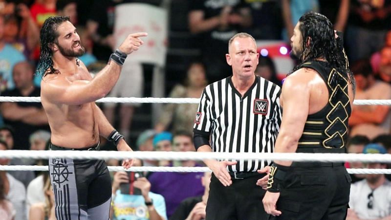 Seth Rollins pointing at Roman Reigns