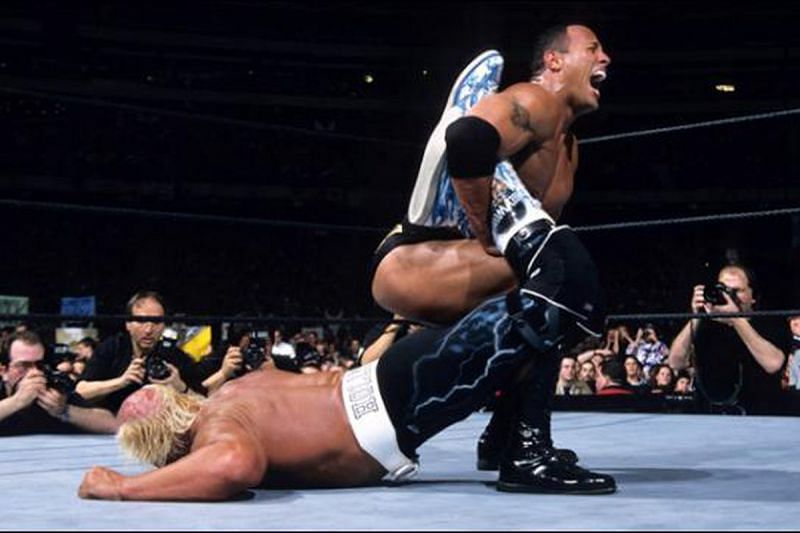 Hollywood Hogan in the clutches of a sharpshooter by the Rock.