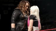 Nia Jax staring down her smaller opponent