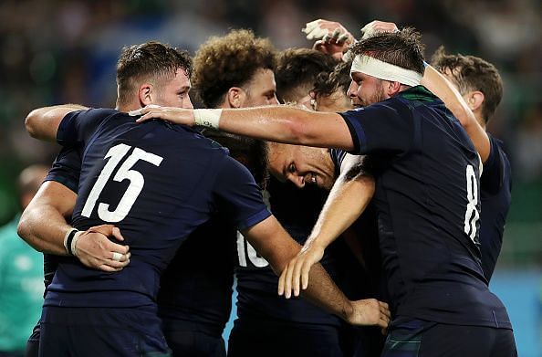 Scotland trounced Russia 61-0 to keep their quarter-final dreams alive.