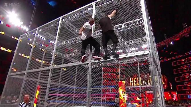 Shane McMahon and Kevin Owens hang from the side of the Cell in 2017.