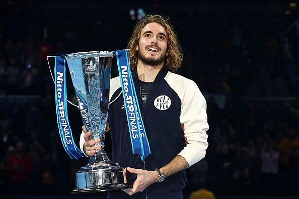Stefanos Tsitsipas poses with the ATP Finals 2019 trophy
