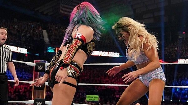 Asuka hitting Charlotte Flair with the green mist at Survivor Series