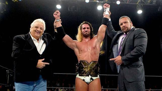 Seth Rollins, NXT Champion, alongside Dusty Rhodes and Triple H