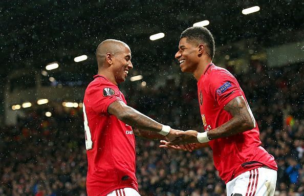 Ashley Young and Marcus Rashford celebrate under the falling snow.